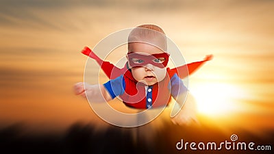 Toddler little baby superman superhero with a red cape flying th Stock Photo