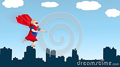 Toddler little baby superman superhero with red cape flying thro Stock Photo