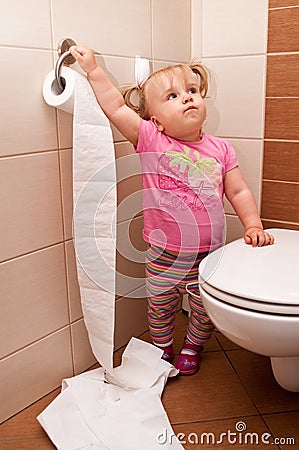 Toddler playing in bathroom Stock Photo