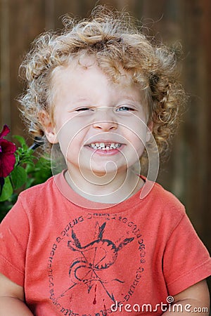 Toddler with ringlets & missing tooth Stock Photo