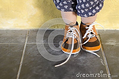 Toddler standing while wearing brown shoes Stock Photo