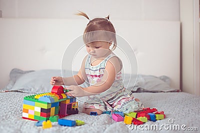 Toddler with tails play with constructor lifestyle Stock Photo