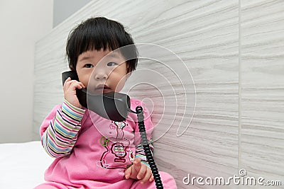 Toddler talking on the phone Stock Photo