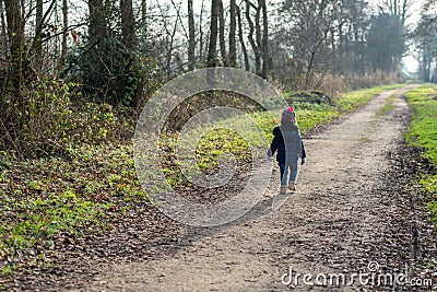 Toddler walking alone on a desolate country road Editorial Stock Photo