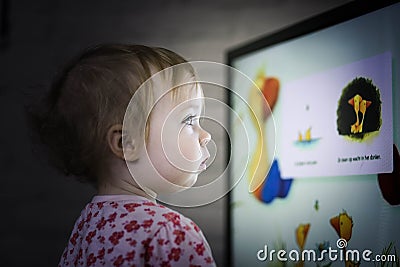Toddler watching television Stock Photo