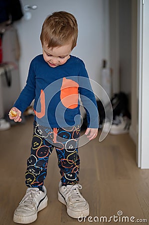 Toddler wearing his father shoes Stock Photo