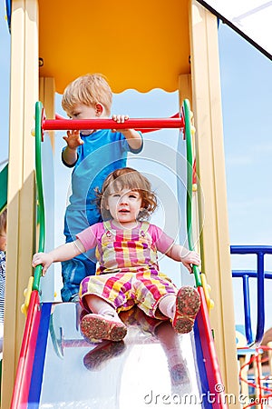 Toddlers on a chute Stock Photo