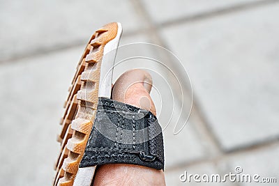 Toe of boy foot in black sandal with grooved sole closeup Stock Photo