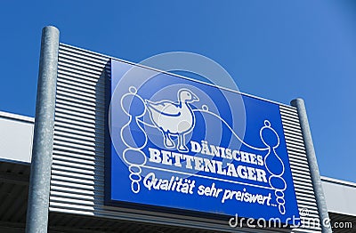 TOENISVORST, GERMANY - JUIN 28. 2019: Close up of blue logo against blue sky at store front of DÃ¤nisches daenisches Bettenlager Editorial Stock Photo