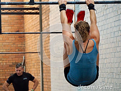 Toes to bar - Athlete mid workout during a high intensity training session Editorial Stock Photo