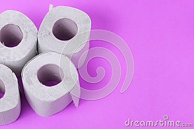 Toilet paper close-up. White paper for household and rubbing the anus from feces. Toiletries on purple background Stock Photo