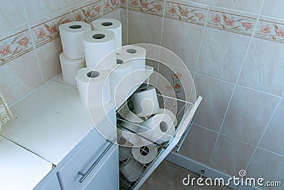 Toilet roll stock piled in home bathroom. Panic buying concept background Stock Photo