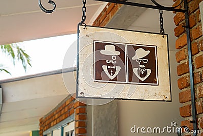 Toilet sign vintage europe man and woman in hats Stock Photo