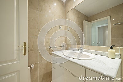 Toilet with white lacquered furniture, granite countertops and walls covered Stock Photo