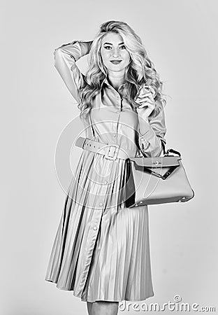 toilette water. lady prefer expensive fragrance smell. sexy girl has curly hair hold bag. woman hold bottle of perfume Stock Photo