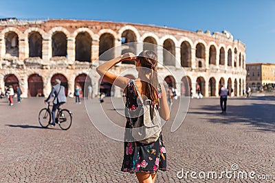 Toirust woman in Verona historical center on square near Arena Verona, Roman amphitheater. Traveler in famous travel destination Stock Photo