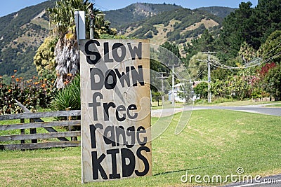 Informal road sign asking vehicles to slow down Editorial Stock Photo