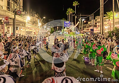 Tokushima, Japan - August 12, 2022: Performers parade down street during crowded Awaodori festival Editorial Stock Photo