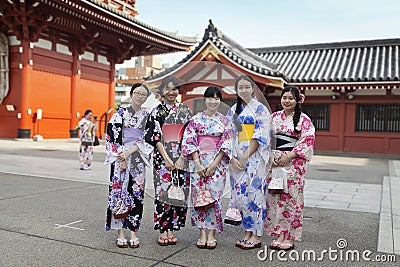 TOKYO - CIRCA JUNE, 2016: Japsnese teenage girls in kimonos at Sensoji-ji Red Japanese Temple in Asakusa, Tokyo, Japan Editorial Stock Photo