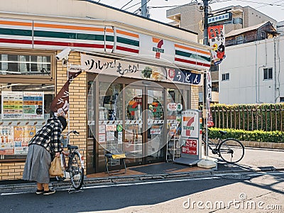 TOKYO, JAPAN - APR 15, 2019 : 7-Eleven convenience store Front Shop with People Japan Business Editorial Stock Photo
