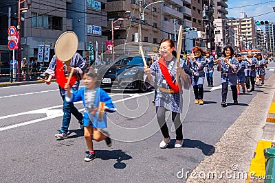 People parade through a street to Nezu-jinja shrine in Bunkyo Azalea Festival in Tokyo, japan Editorial Stock Photo