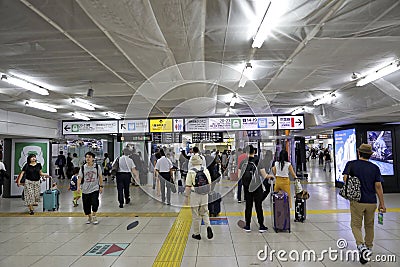 Crowded of Japanese people in tokyo train station on prime time with sign directions , Tokyo Editorial Stock Photo