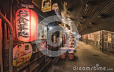 Night view of the Yuraku Concourse underpass under the railway line of the station Yurakucho. Japanese noodle stalls and sake bars Editorial Stock Photo