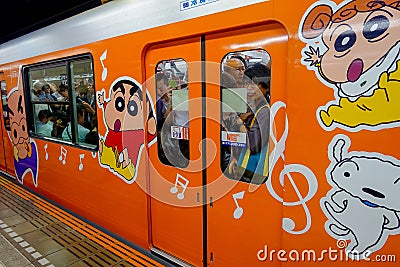 TOKYO, JAPAN - CIRCA MAY 2014: Crowd of passengers inside of train at Ikebukuro station in Tokyo, Japan. Ikebukuru is Editorial Stock Photo