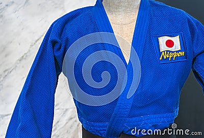 Japanese blue Judo uniform adorned with Japan national flag and word Nippon. Editorial Stock Photo