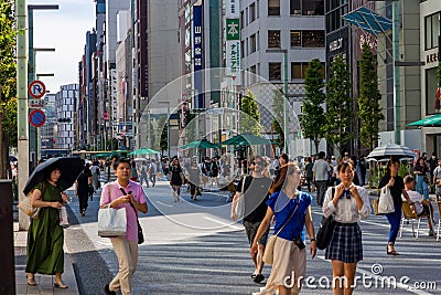 TOKYO, JAPAN - JULY 30 2023: Shoppers on the closed roads of Ginza, the luxury retail district of central Tokyo Editorial Stock Photo