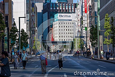 TOKYO, JAPAN - JULY 30 2023: Shoppers on the closed roads of Ginza, the luxury retail district of central Tokyo Editorial Stock Photo