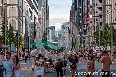 TOKYO, JAPAN - JULY 30 2023: Shoppers on the closed roads of Ginza, the luxury retail district of central Tokyo Editorial Stock Photo