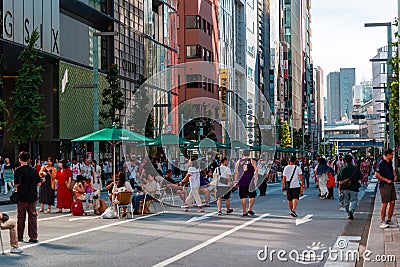 TOKYO, JAPAN - JULY 30 2023: Shoppers on the closed roads of Ginza, the luxury retail district of central Tokyo Editorial Stock Photo