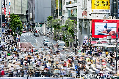 TOKYO, JAPAN - JUNE 21 2023: Long exposure single image of crowds using the famous Shibuya Crossing in Tokyo, Japan Editorial Stock Photo