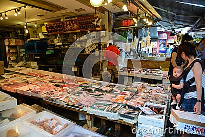 Tokyo, Japan - June 18, 2015 : Merchants sale seafood in Tsukiji fish in Tokyo, Japan. Tsukiji fish market is one of biggest fish Editorial Stock Photo