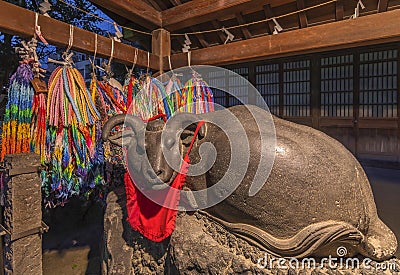 Thousand origami cranes and Nadeushi lucky cow at Ushijima shrine. Editorial Stock Photo