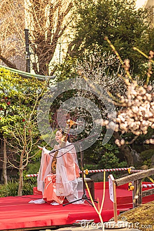 Japanese biwa lute demonstration by a Japanese woman in a kimono in the Yushima Tenmangu temple Editorial Stock Photo