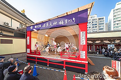 Japanese Wadaiko or Taiko drums played by boys and girls in short happi kimono with hachimaki on Editorial Stock Photo