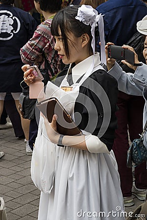 Tokyo, Japan - Cosplay girl as a maid in the street Editorial Stock Photo