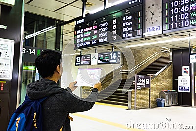 Tokyo, Japan - May 11, 2017 : Asian tourist reading subway map o Editorial Stock Photo