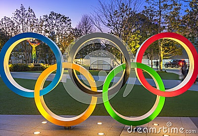 Olympic Rings lighted up at dusk on the japan sport olympic square of Tokyo. Editorial Stock Photo