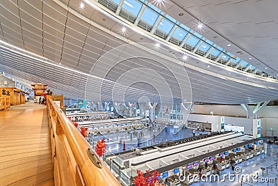 Traditional haneda-nihonbashi bridge overlooking the modern departure lobby of Haneda Airport. Editorial Stock Photo