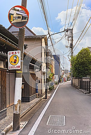 Playground zone warning sign and convex mirror in a Japanese neighborhood street. Editorial Stock Photo