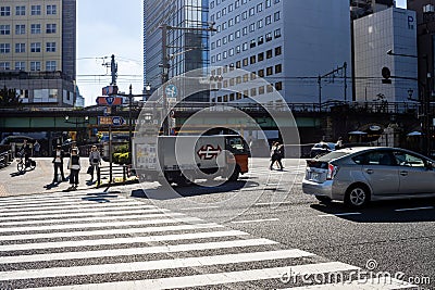 Tokyo, Japan, 26 October 2023: Pedestrians Crossing at a Tokyo Intersection with Overpass Editorial Stock Photo