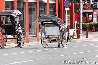 TOKYO, JAPAN - OCTOBER 31, 2017: Rickshaw with a sign for advertising on the streets of the city. Copy space for text. Editorial Stock Photo