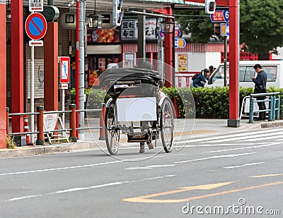 TOKYO, JAPAN - OCTOBER 31, 2017: Rickshaw with a sign for advertising on the streets of the city. Copy space for text. Editorial Stock Photo