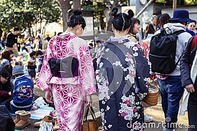 Tokyo, Japan, 04/04/2017: Young girls in a kimono on the city streets. Back view Editorial Stock Photo