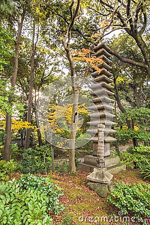 Tokyo Metropolitan Park KyuFurukawa japanese garden`s ruins of a giant thirteen storied stone pagoda Kuyoto Stock Photo