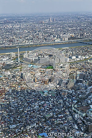 Tokyo top view. A densely-built metropolis from the height of the Sky Three tower. Vertical Editorial Stock Photo