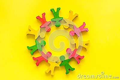 Tolerance, social protection, anti-discrimination concept. Wooden human figures on yellow table, top view Stock Photo